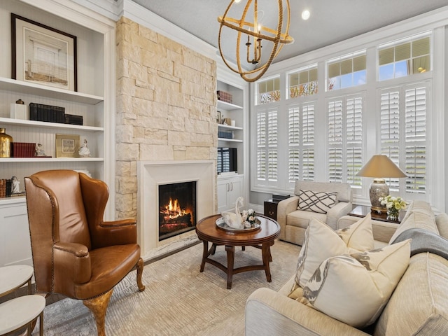living area featuring wood finished floors, a fireplace, a chandelier, built in shelves, and ornamental molding