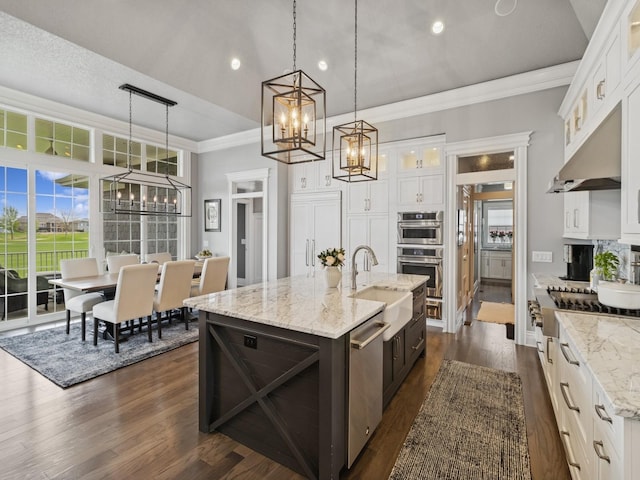 kitchen with pendant lighting, an inviting chandelier, appliances with stainless steel finishes, and a sink