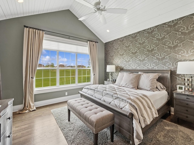 bedroom with lofted ceiling, recessed lighting, wallpapered walls, baseboards, and wood-type flooring