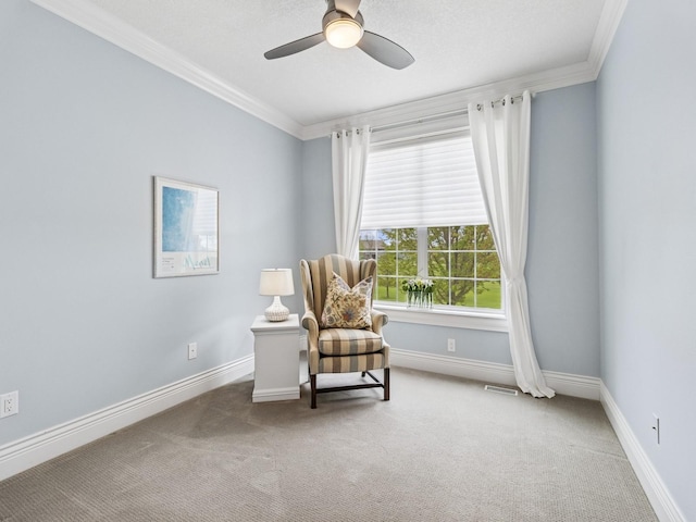 living area featuring a ceiling fan, carpet floors, crown molding, visible vents, and baseboards