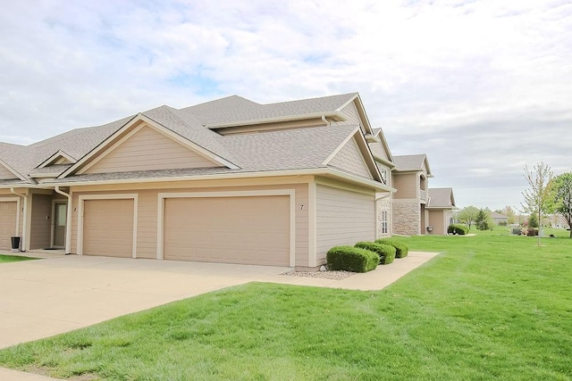 view of front of home with a front lawn, a shingled roof, a garage, and concrete driveway