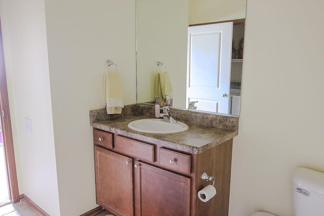 bathroom featuring vanity and toilet