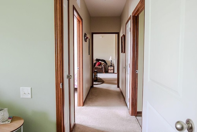 corridor with light colored carpet and baseboards