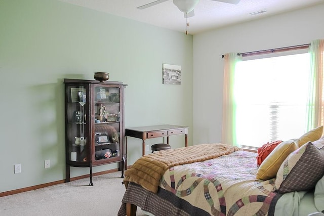 bedroom featuring carpet flooring, baseboards, visible vents, and multiple windows