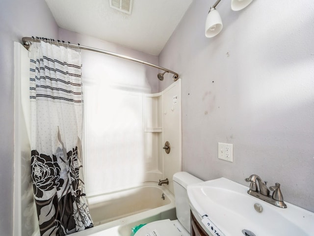 bathroom featuring toilet, visible vents, a sink, and shower / bathtub combination with curtain