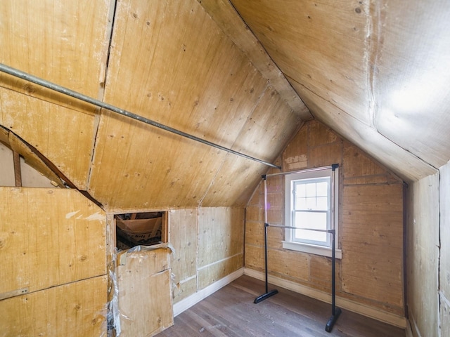 bonus room with wood ceiling, wood finished floors, baseboards, wooden walls, and lofted ceiling
