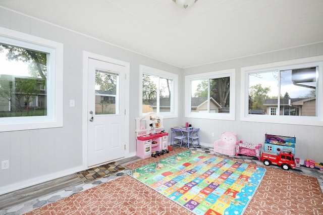 game room with baseboards and wood finished floors