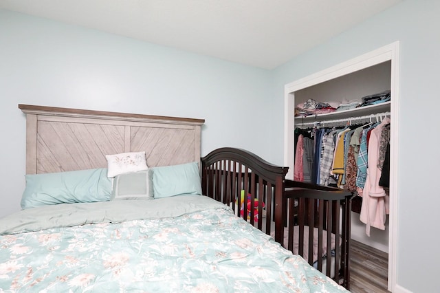 bedroom featuring a closet, baseboards, and wood finished floors