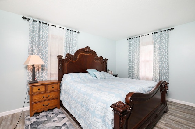 bedroom featuring baseboards and wood finished floors