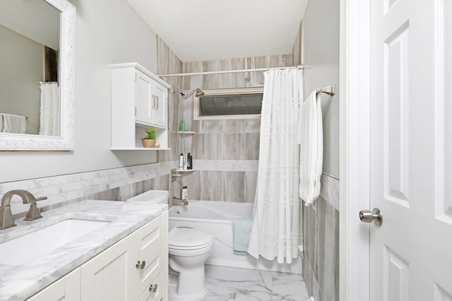 bathroom with toilet, shower / bath combo, tile walls, marble finish floor, and vanity