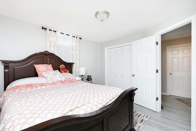 bedroom featuring a closet and light wood-type flooring