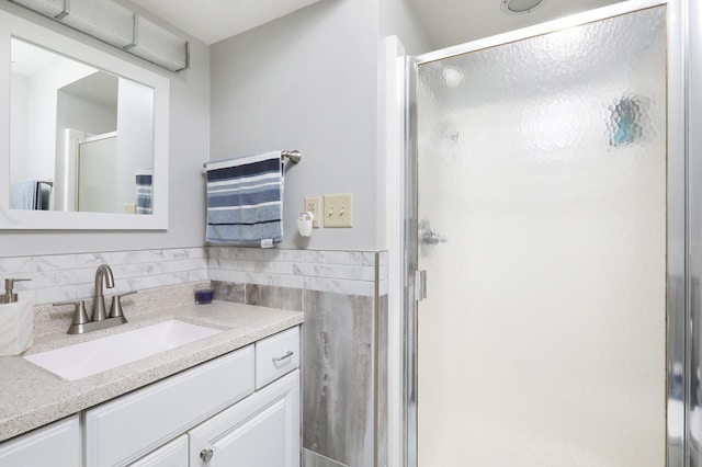 bathroom featuring a stall shower and vanity