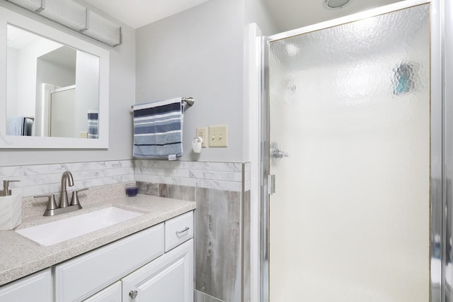 bathroom with vanity and a shower stall
