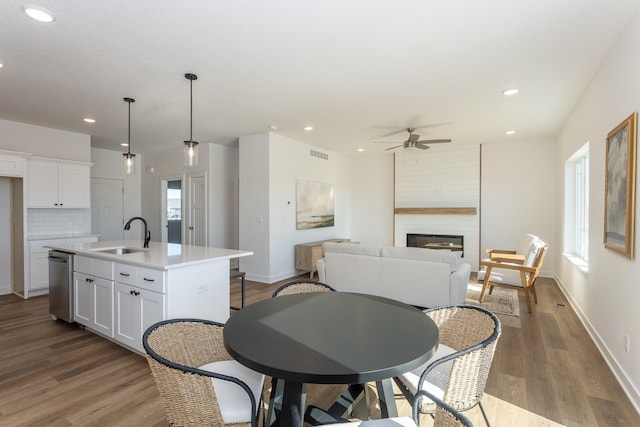 935 11th St, Waukee, IA 50263 - dining room with ceiling fan, wood finished floors, a large fireplace, recessed lighting, and plenty of natural light