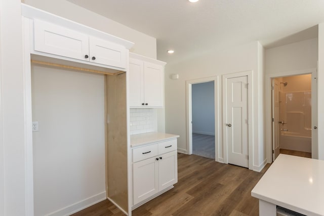 935 11th St, Waukee, IA 50263 - kitchen with light countertops, white cabinetry, dark wood-style floors, recessed lighting, and tasteful backsplash
