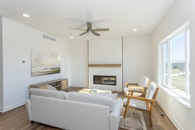 935 11th St, Waukee, IA 50263 - living room featuring wood finished floors, ceiling fan, a fireplace, and recessed lighting