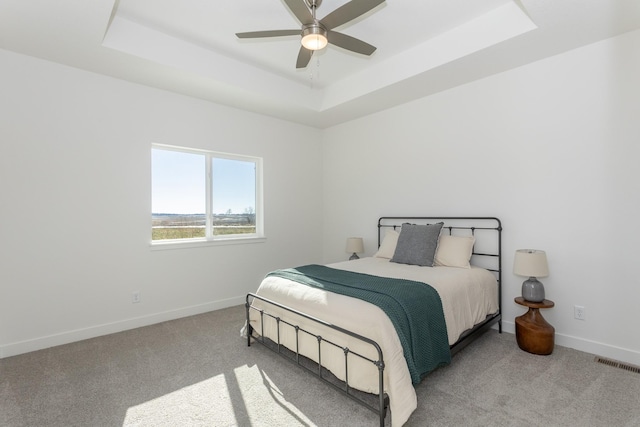 935 11th St, Waukee, IA 50263 - carpeted bedroom with a raised ceiling and ceiling fan