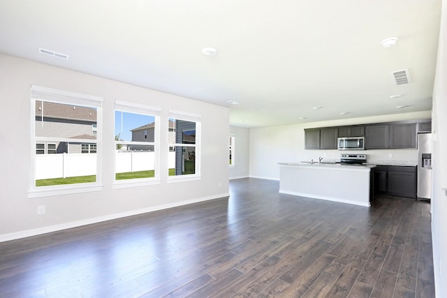 4207 NW Cedarwood Dr, Ankeny, IA 50023 - unfurnished living room featuring dark wood-style floors, baseboards, and a sink