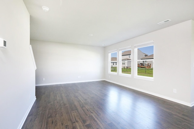 4207 NW Cedarwood Dr, Ankeny, IA 50023 - empty room with dark wood finished floors, baseboards, and a smoke detector
