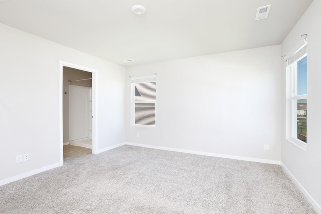 4207 NW Cedarwood Dr, Ankeny, IA 50023 - carpeted empty room with baseboards and healthy amount of natural light