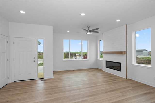 955 11th St, Waukee, IA 50263 - unfurnished living room with a ceiling fan, baseboards, a large fireplace, light wood-type flooring, and recessed lighting