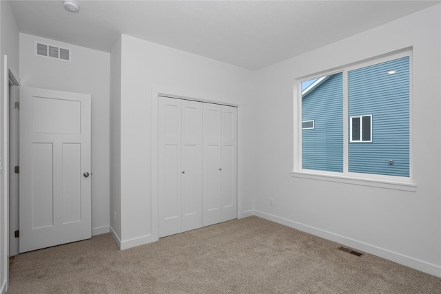 955 11th St, Waukee, IA 50263 - unfurnished bedroom featuring carpet flooring, baseboards, and a closet