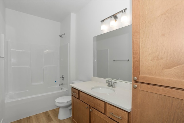 955 11th St, Waukee, IA 50263 - bathroom with toilet, wood finished floors, vanity, and bathing tub / shower combination