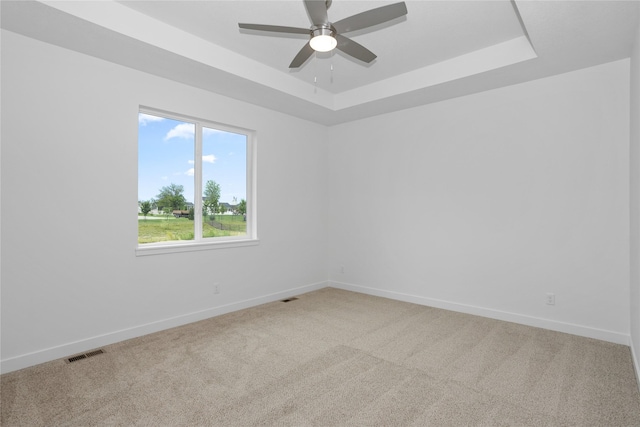 955 11th St, Waukee, IA 50263 - empty room featuring a raised ceiling, light carpet, baseboards, and ceiling fan