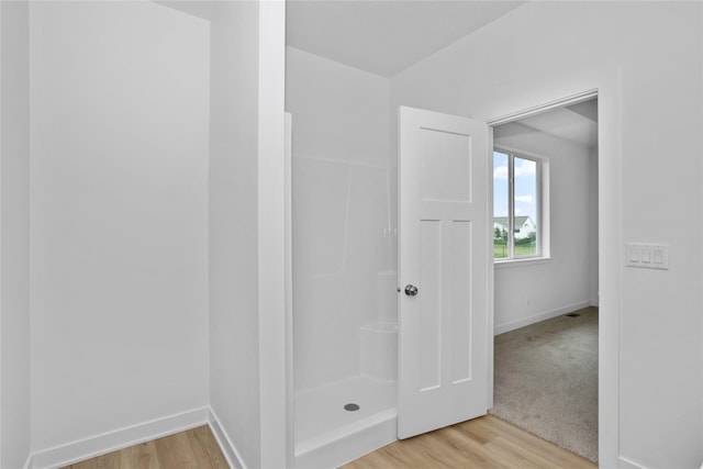 955 11th St, Waukee, IA 50263 - full bathroom featuring wood finished floors and a shower