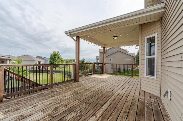 wooden terrace with a lawn and a residential view
