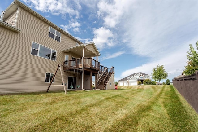 rear view of house featuring a yard, stairs, and a deck