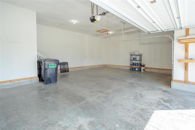 garage with baseboards and a garage door opener