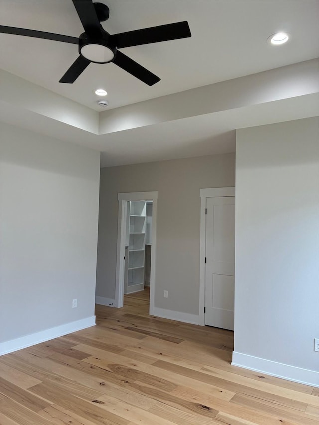 empty room featuring ceiling fan, recessed lighting, baseboards, and light wood-style floors