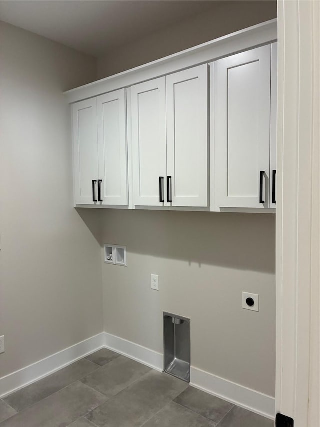 clothes washing area featuring cabinet space, dark tile patterned floors, electric dryer hookup, washer hookup, and baseboards