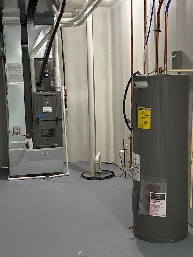 utility room with heating unit and electric water heater