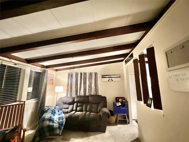 living area with beamed ceiling