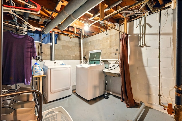2216 Lay St, Des Moines, IA 50317 - laundry area featuring separate washer and dryer and concrete block wall