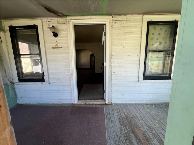 entrance to property featuring brick siding