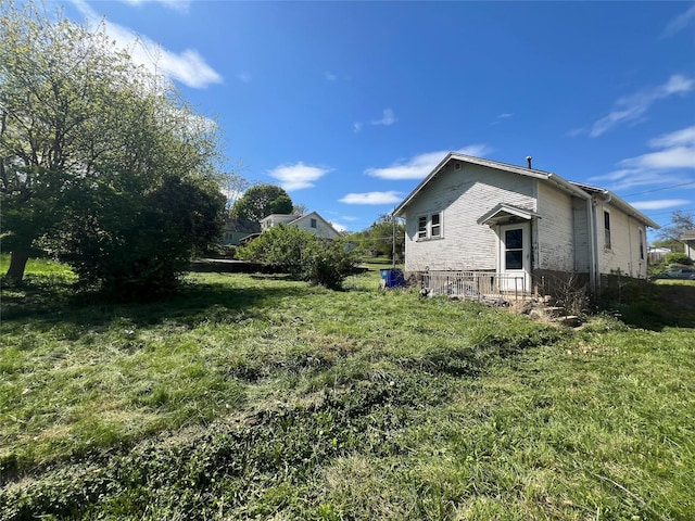 view of side of home with a lawn