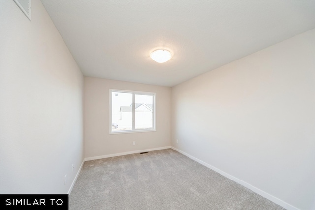 empty room with light carpet, baseboards, and visible vents
