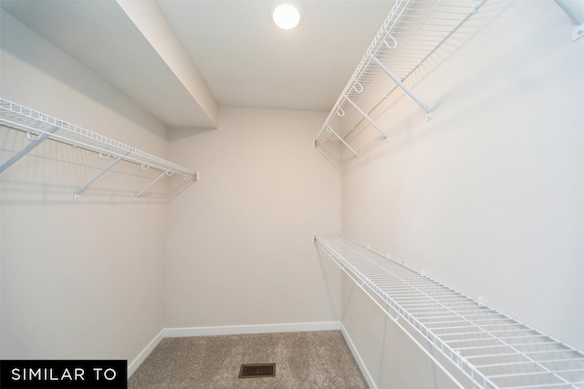 walk in closet with carpet floors and visible vents