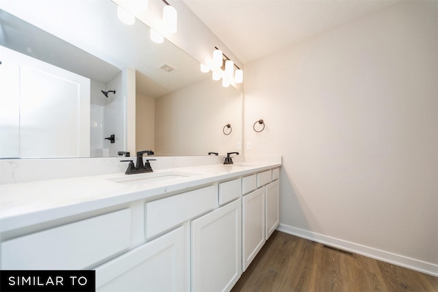 full bathroom with double vanity, visible vents, baseboards, and a sink