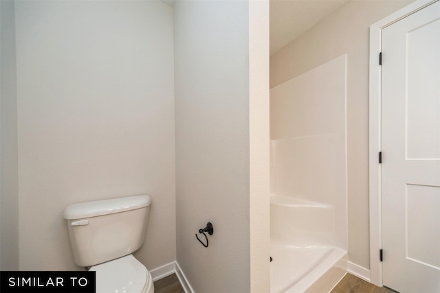 full bathroom with toilet, baseboards, a shower, and wood finished floors