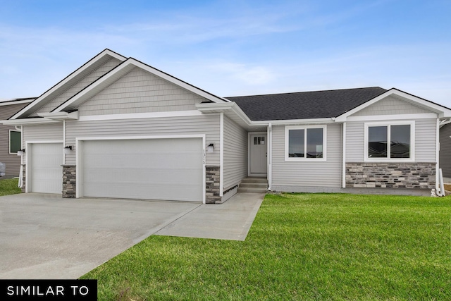 view of front facade featuring driveway, an attached garage, stone siding, and a front yard