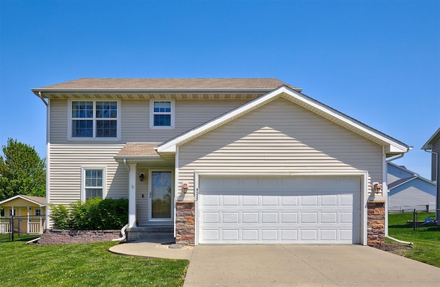 traditional home featuring stone siding, an attached garage, driveway, and a front yard