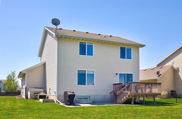 back of property with a lawn, stairway, fence, and a deck