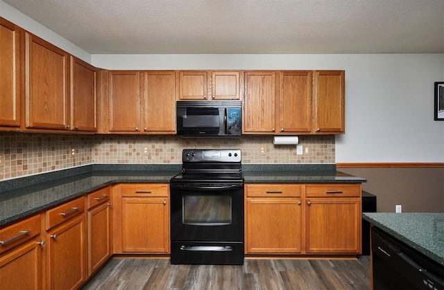 kitchen with dark wood-style flooring, black appliances, and brown cabinets