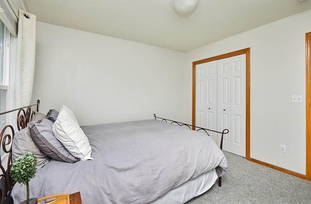 bedroom featuring baseboards, a closet, and carpet floors