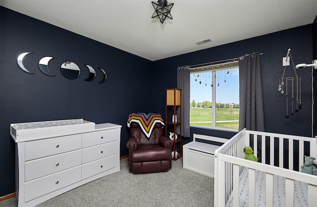 bedroom featuring carpet flooring, a nursery area, visible vents, and baseboards