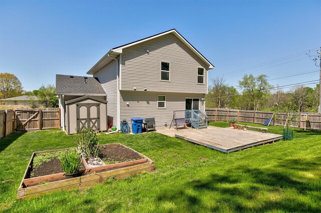 5301 SE 27th St, Des Moines, IA 50320 - back of house featuring a vegetable garden, a storage shed, a deck, and an outdoor structure